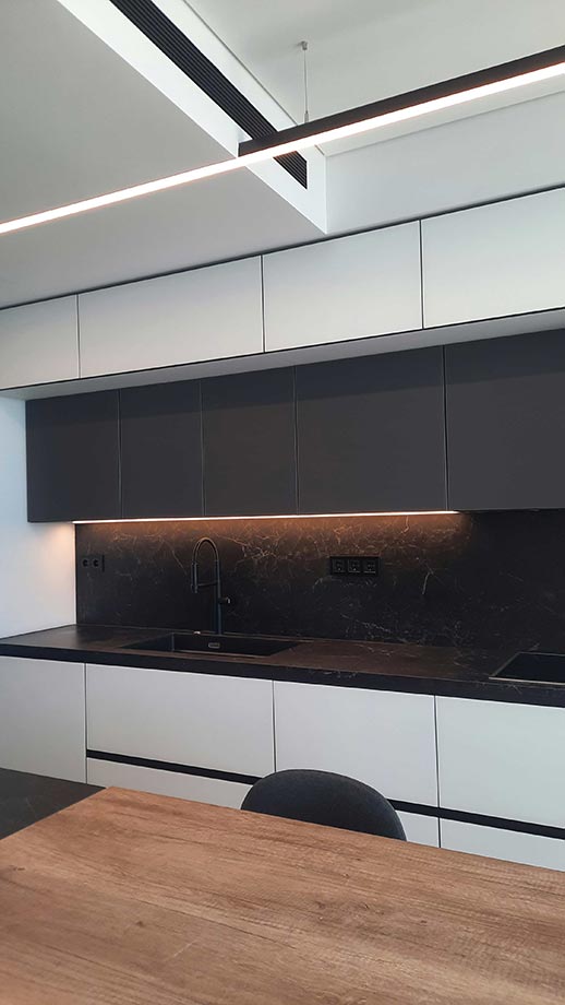 Κουζίνα σε άσπρο μαύρο και επένδυση πλάτης με κεραμική επιφάνεια